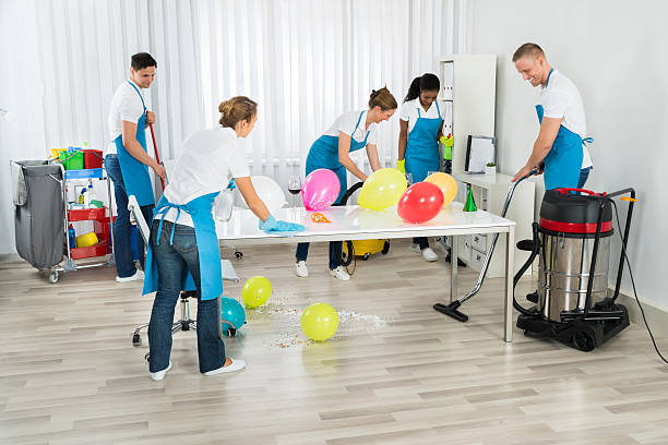 Janitors Cleaning The Office After Party Group Of Male And Female Janitors Cleaning The Office After Party after party stock pictures, royalty-free photos & images