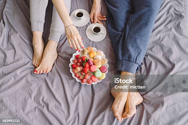 Young Caucasian Couple Having Romantic Breakfast In Bed Stock Photo - Download Image Now