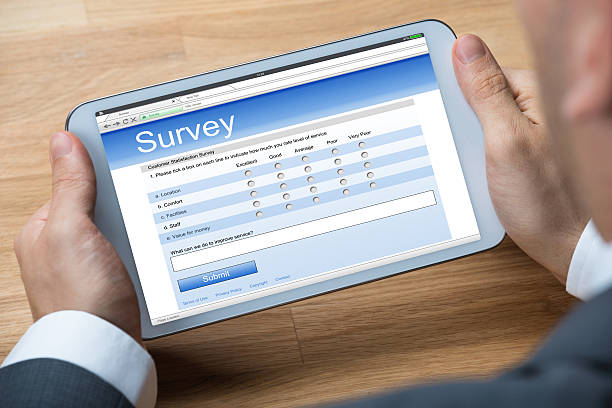 istock Businessman Giving Online Survey On Digital Tablet 583992698
