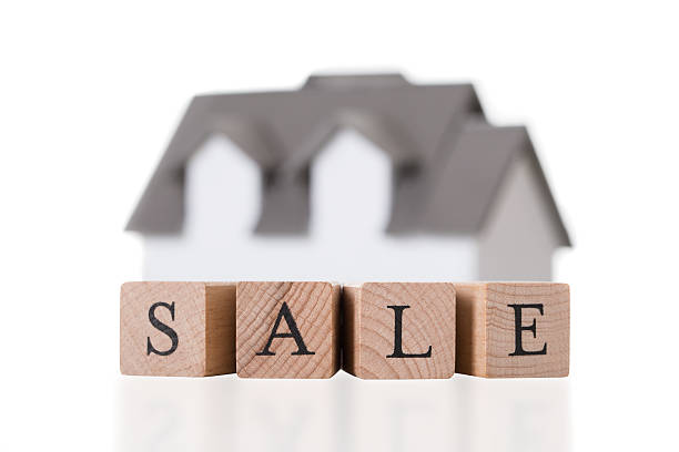 istock Closeup Of House Model On Sale Blocks 583992980