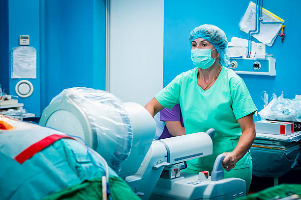 medical assistant with a c-arm fluoroscope verifying spine surgeons work. - nuclear monitoring bildbanksfoton och bilder