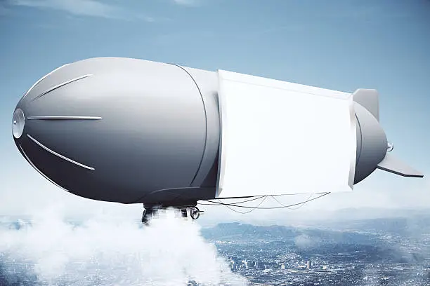 Sideview of airship with blank billboard in the sky above city. Mock up, 3D Rendering