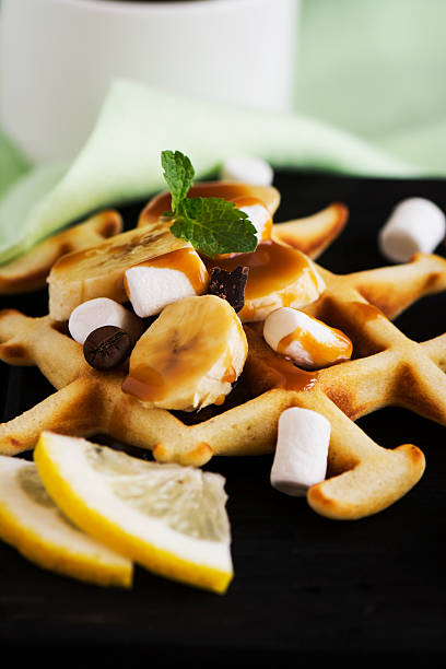 istock Thick belgium waffles with banana and marshmallows 583994540