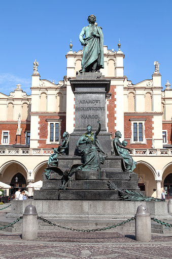 Krakow, Poland - June 26, 2016:  Bronze statue of Adam Mickiewicz, Main Market Square, Old Town. He was  the greatest Polish Romantic poet of the 19th century. The inscription on the pedestal reads: \