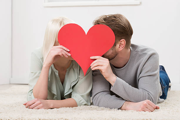 istock Couple Kissing Behind Heart Shape 583995892