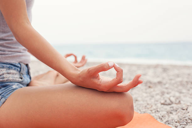 istock Meditating. Woman doing yoga. Close-up 583996330