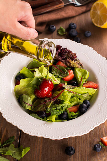 istock Fresh summer salad with berries and green leaves 583998010