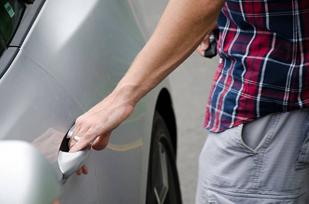 istock Man entering car door. 583998820