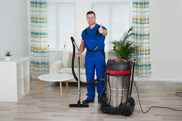 istock Janitor Showing Thumbs Up While Holding Vacuum Cleaner At Home 583999478