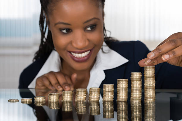 istock Businesswoman Making Stack Of Coins 584001990