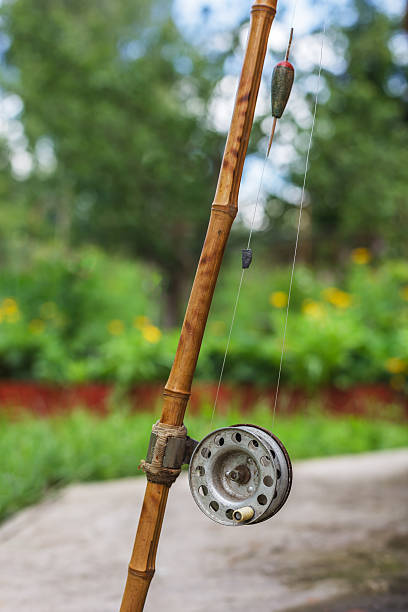 Old Fishing Rod On Nature Background Stock Photo - Download Image