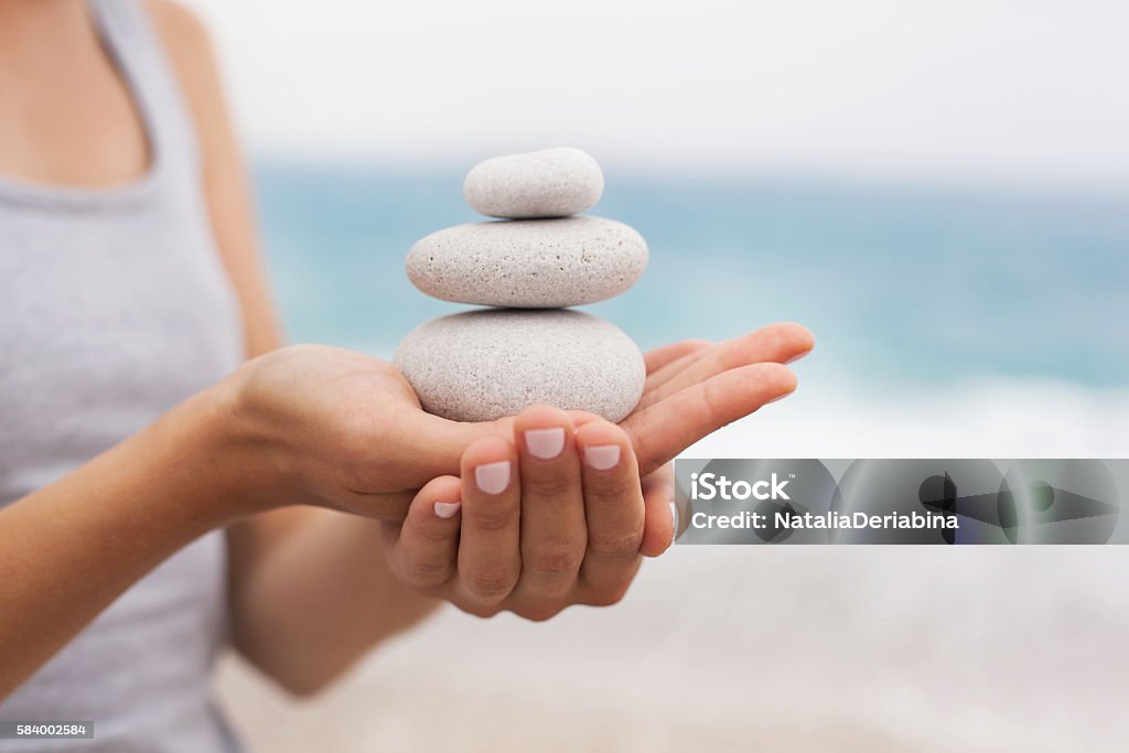 Concept of Relaxation and Balance Beautiful young woman in a state of harmony on the background of the ocean Balance Stock Photo