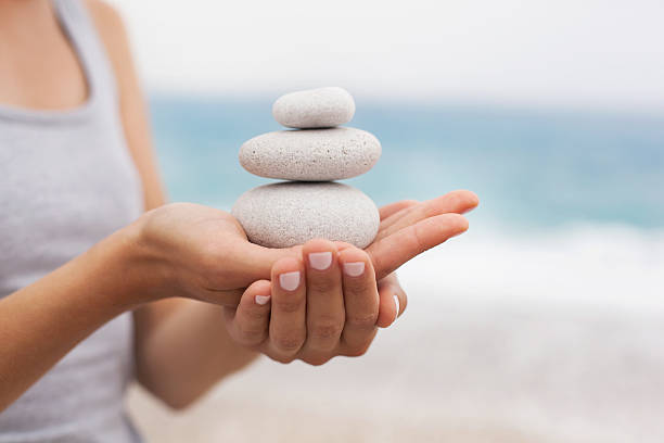 Concept of Relaxation and Balance Beautiful young woman in a state of harmony on the background of the ocean meditation hands stock pictures, royalty-free photos & images