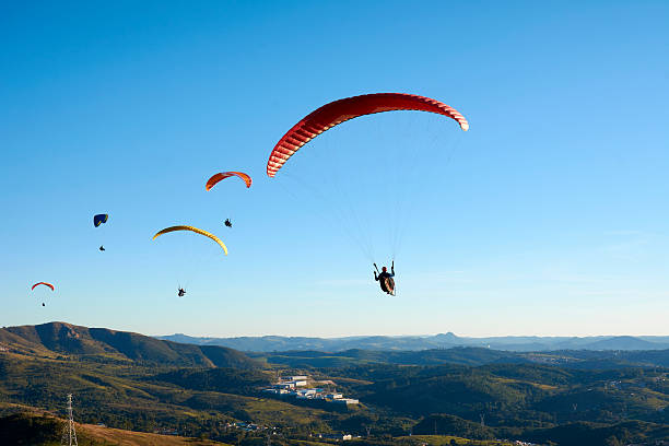 Paragliding flying over mountains stock photo