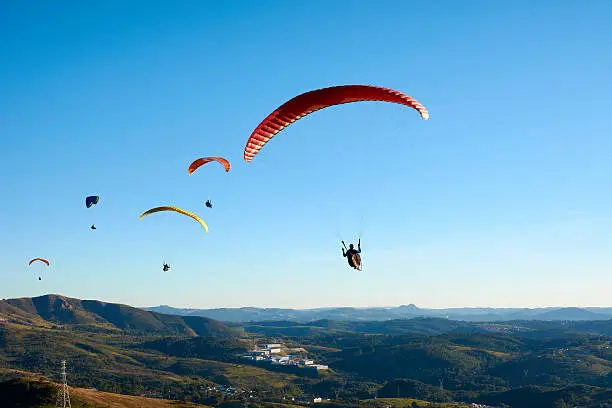 Photo of Paragliding flying over mountains