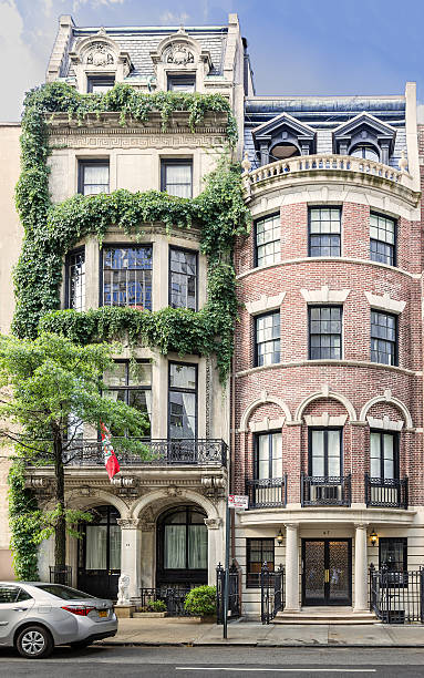 Manhattan Upper East Side Townhouses (Row houses), New York City. New York, NY, USA - June 29, 2016: Manhattan Upper East Side Townhouses (Row houses), New York City. Green trees, street, sidewalk, stoop, steps and blue sky are in the image. Canon EOS 6D (full frame sensor) and Canon EF 24-105mm f/4 L IS lens. upper east side manhattan stock pictures, royalty-free photos & images