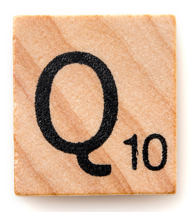 Miami, Florida, USA - December 7, 2015: Scrabble game board Lettered wooden tile showing the letter Q. Scrabble is a fun and educational game distributed by Hasbro