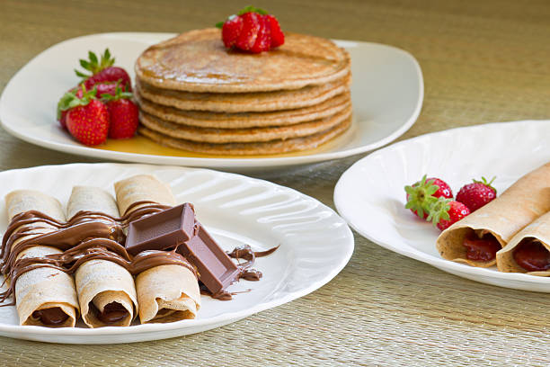Thin pancakes with strawberries and chocolate cream. Pancakes with fresh strawberries. Free space