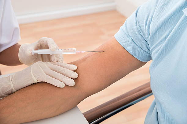 istock Doctor Injecting Patient With Syringe 584202736