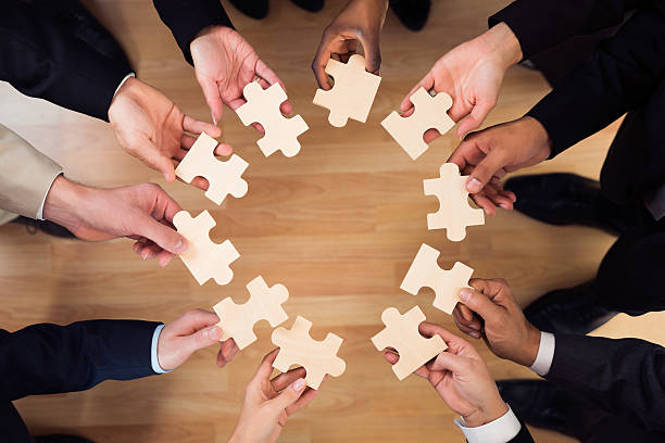 istock Business People Joining Puzzle Pieces In Office 584202968