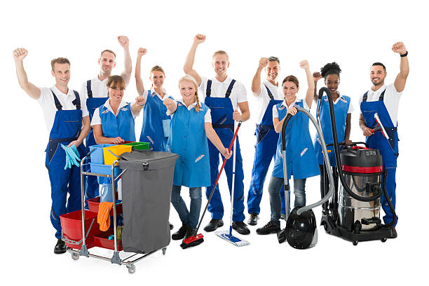 istock Happy Janitors With Arms Raised Holding Cleaning Equipment 584203366