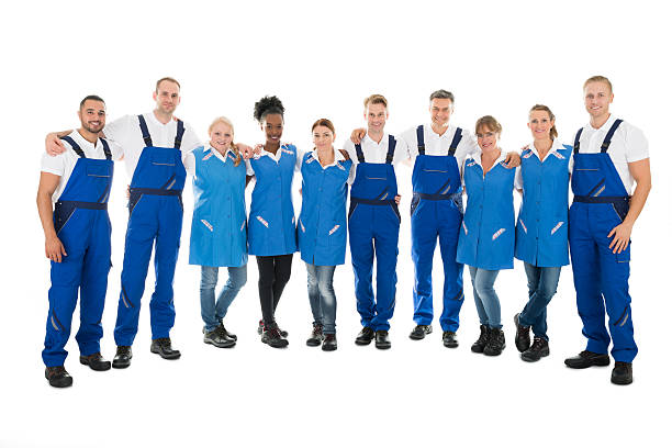 istock Confident Multiethnic Janitors Standing With Arms Around 584203486