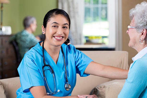 istock Caring medical professional holding hands with senior patient 584203910