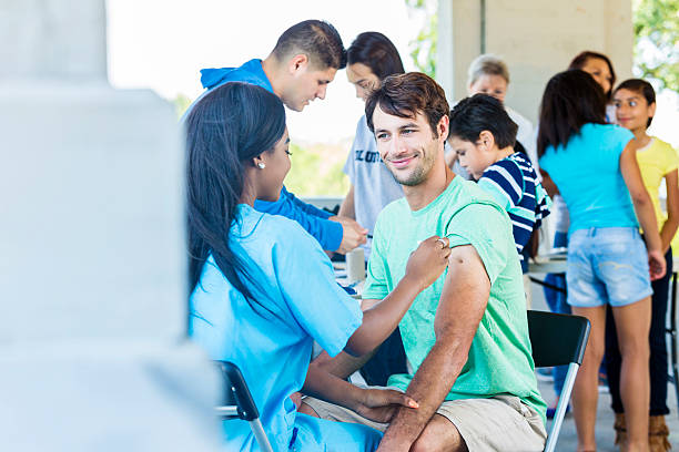 istock Free shot clinic a man recieving a vaccination 584204180