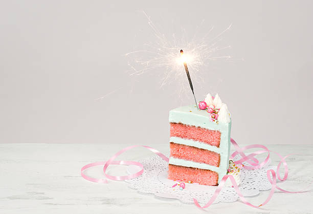 istock Slice of Birthday Cake with sparkler 584205058