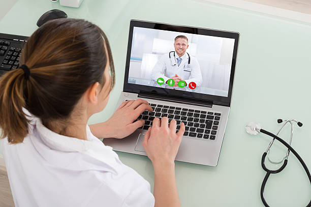 istock Female Doctor Video Chatting On Laptop 584205882