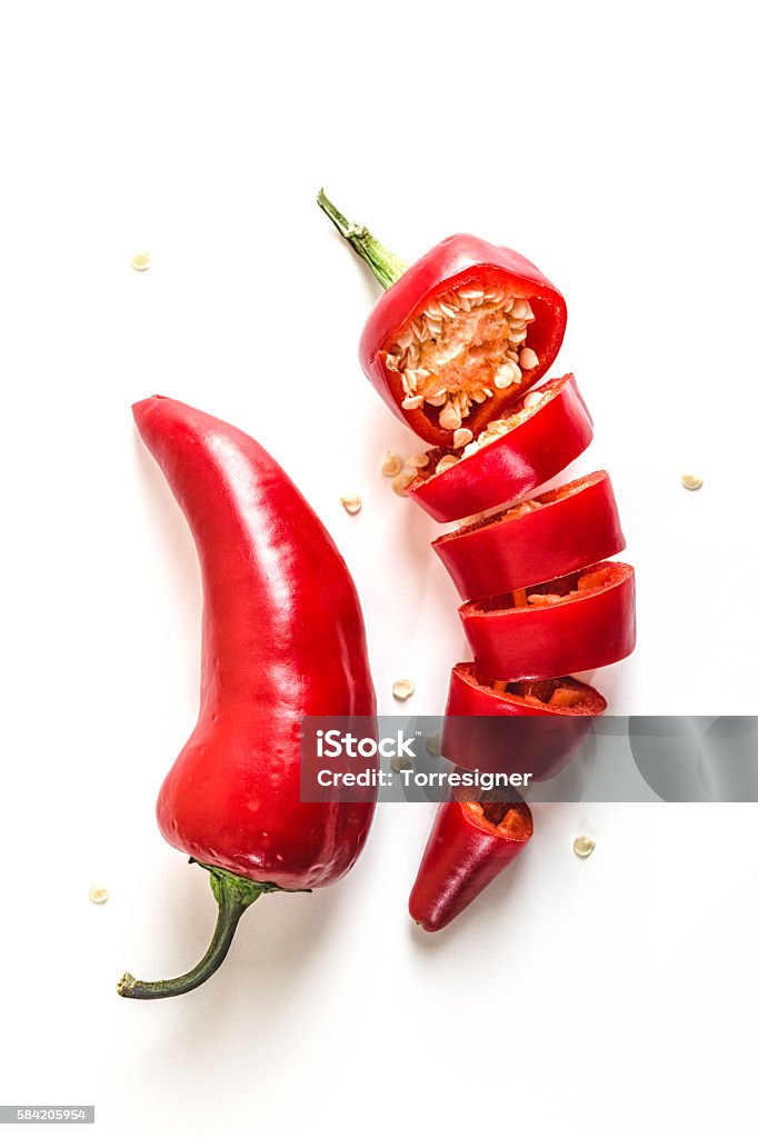 Red Chili Peppers Sliced on White Background Red chili peppers sliced and isolated on white background. Chili Pepper Stock Photo