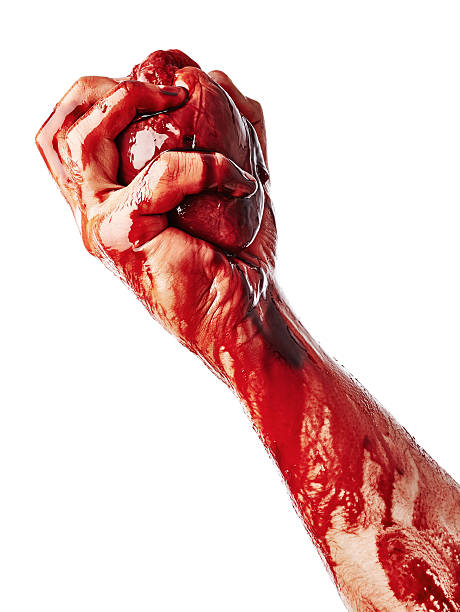 Bloody heart in male hand stock photo