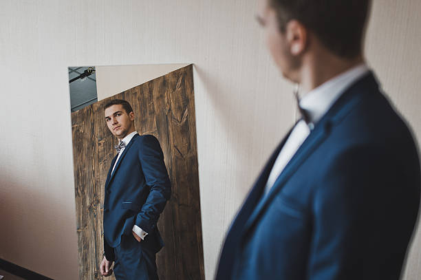 istock Man looks in the mirror 584206640