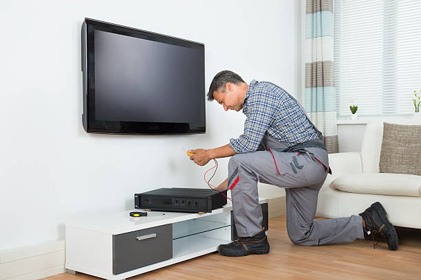 istock Technician Installing TV Set Top Box At Home 584206886