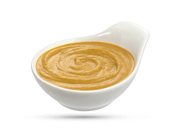 istock Mustard in bowl isolated on white background 584207618