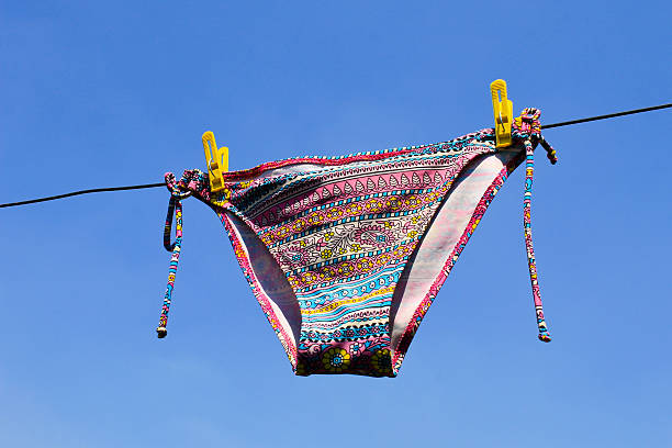 istock Drying woman swimsuit against the blue sky 584208686