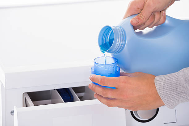 istock Woman Pouring Detergent With Washing Machine In Background 584210302