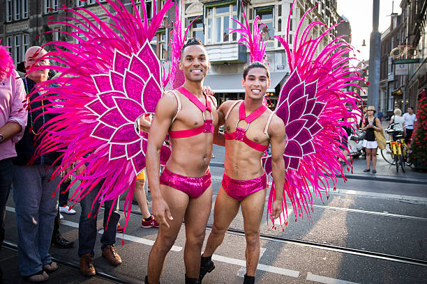 Amsterdam, the Netherlands - July 23, 2016: handsome young men dressed as pink butterflies at Pride Walk, demonstration parade from Vondelpark to Dam Square, Pink Saturday Gay Euro Pride celebrations
