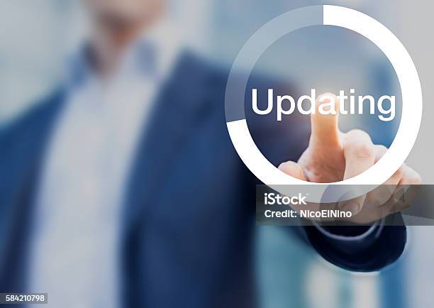 Software Updating Button With Person Touching Button On The Screen Stock Photo - Download Image Now