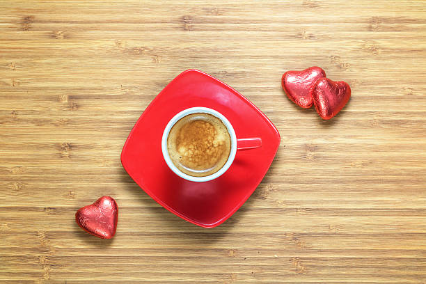 istock Heart shaped sweets wrapped in a bright red foil lying 584211726