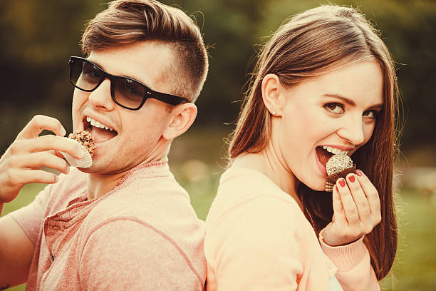 istock Lovely couple eating cupcakes. 584213596
