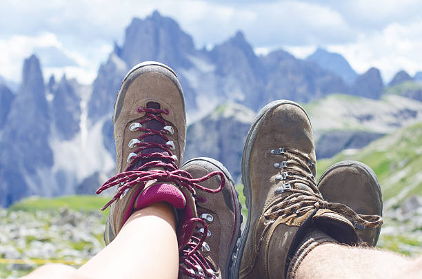 istock Man hiker lie on a ground. Peaks like a background. 584213784