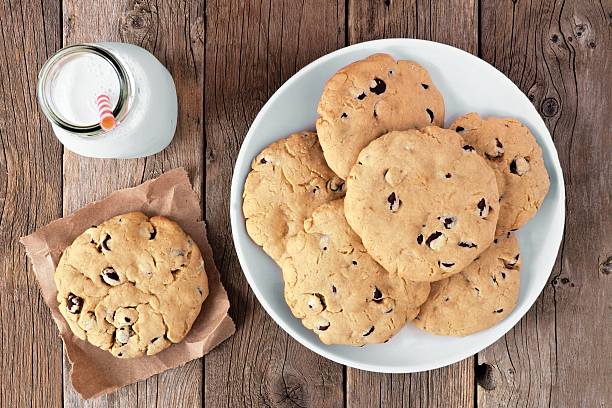 traditional chocolate chip cookies and milk on rustic wood - milk milk bottle drinking straw cookie imagens e fotografias de stock