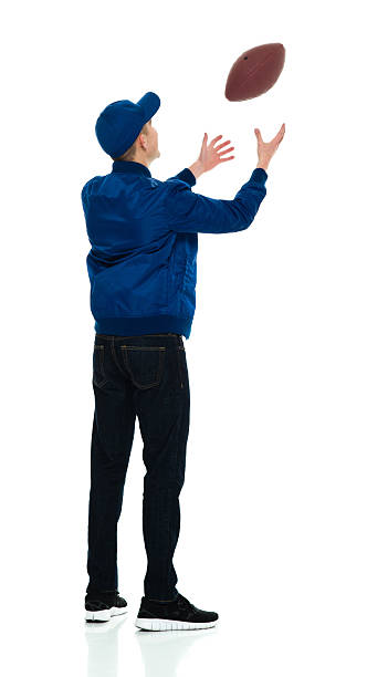 istock Rear view of male throwing ball 584215192
