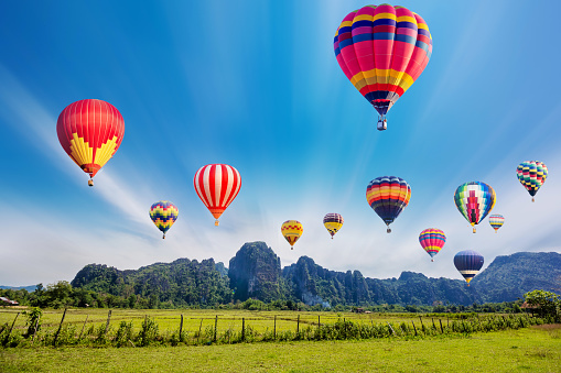 Colourful hot-air balloons flying over the mountain.