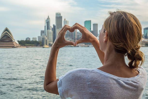 istock Woman framing Sydney skyline into heart shape finger frame 584216836