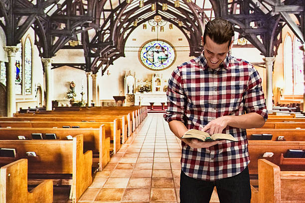 istock Smiling man reading bible in church 584217838