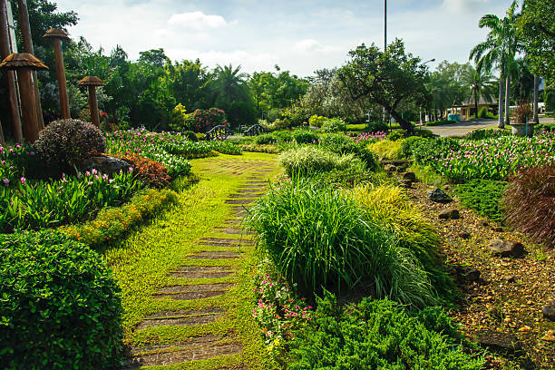 istock Beautiful garden with walkway its way through 584218744