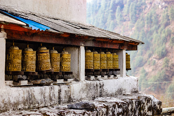 brass prayer wheels with hazy background - iron asian culture buddhism buddha imagens e fotografias de stock