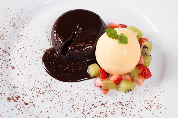 istock Close up cake chocolate lava with ice cream vanilla, strawberry, 584222104